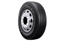 Firestone truck tire with silver wheel rim on white background