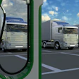 Electric truck charging station with silver semi-trucks parked under blue sky