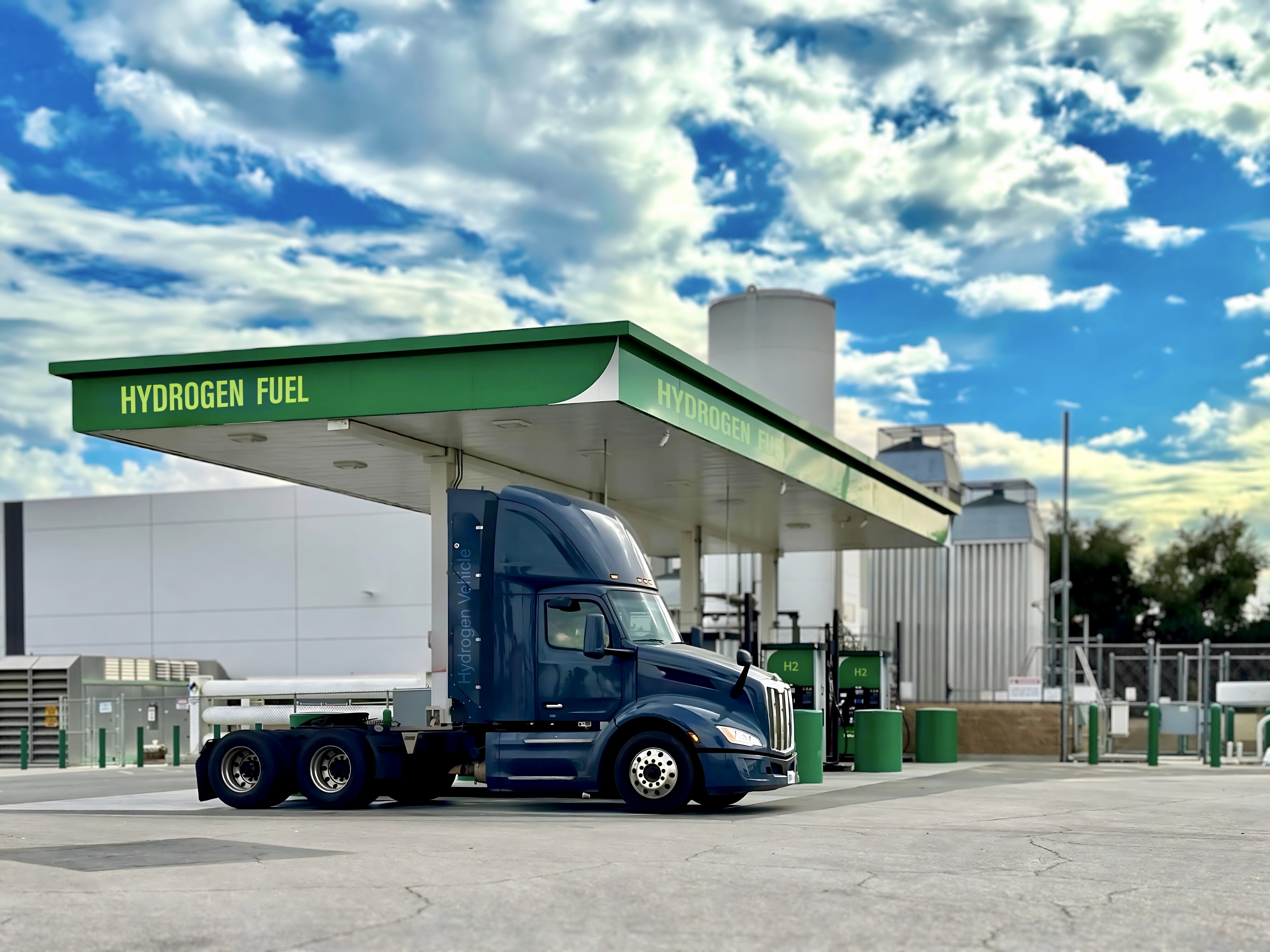 A hydrogen fuel cell Class 8 is shown at a green hydrogen refueling station.