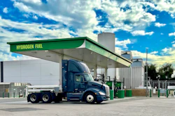 A hydrogen fuel cell Class 8 is shown at a green hydrogen refueling station.