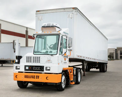 An example of an Orange EV electric yard tractor hauling a trailer.