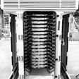 Tesla V4 Supercharger cabinet on display in a warehouse