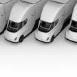 Row of white Tesla Semi electric trucks lined up in parallel formation