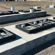 Concrete foundations with metal equipment bases on construction site