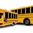 Two yellow school buses parked side by side against white background