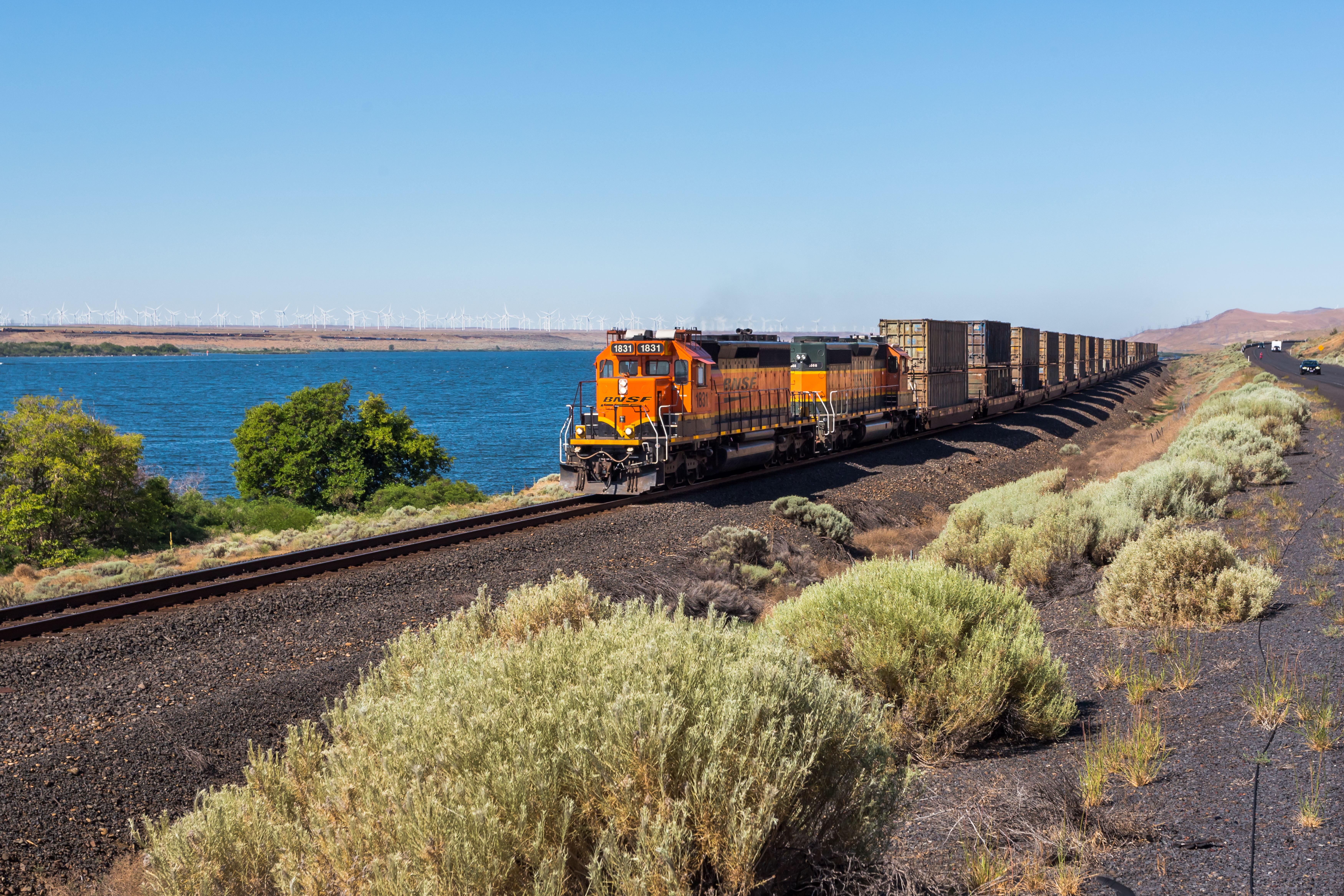 Moving BNSF locomotive in the desert area near the highway