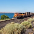 Moving BNSF locomotive in the desert area near the highway