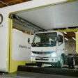 White Mitsubishi electric truck inside Ample charging station