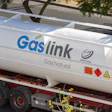 White Gaslink natural gas tanker truck with red wheels parked on roadside