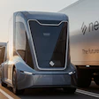 Futuristic autonomous electric truck with NexDash branding on highway at sunset