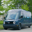 Blue Amazon delivery van parked on residential street with trees and house