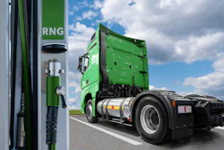 A renewable natural gas (RNG)-powered semi truck parked at a refueling station.