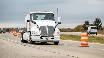 An electric heavy-duty truck provided by Cummins charges as it drives along a test segment on U.S. Highway 52/U.S. Highway 231 in West Lafayette, Indiana.