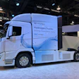 White Hyundai hydrogen truck on display with water splash graphic at industry event