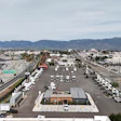 Aerial view of truck depot with highways and mountain landscape
