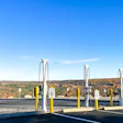 Electric vehicle charging station with multiple charging points overlooking fall foliage