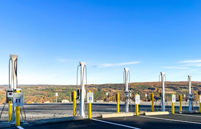 Electric vehicle charging station with multiple charging points overlooking fall foliage