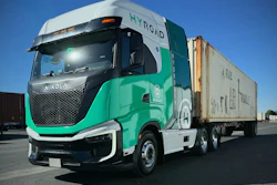 A hydrogen-powered Nikola Tre semi wrapped in a Hyroad Energy livery with a cargo trailer.