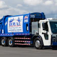 Blue and white Royal Waste Services garbage truck parked in lot