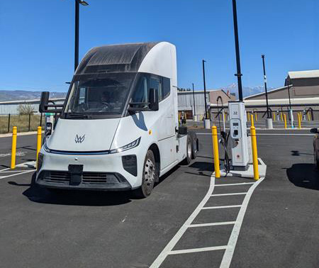 A Windrose truck next to a 1,200 kW Kempower dispenser, capable of providing Megawatt Charging System (MCS) charging at EV Realty's San Bernardino charging hub.