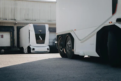 Einride's battery-electric autonomous trucks in action at an industrial warehouse.