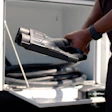Person inserting stapler cartridge into office printer equipment