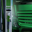 Green truck at RNG charging station with fuel nozzle and dispenser
