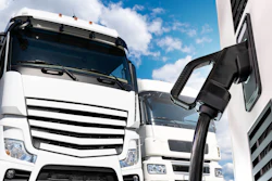 A rendering of a commercial semi-truck connected to a charging cable.