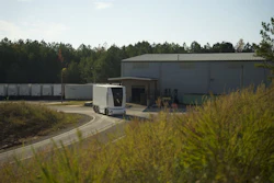 Einride's battery-electric, Level 4 autonomous cab-less truck parked alongside a warehouse during pilot operations.