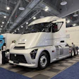 White Workhorse Class 8 electric truck displayed at indoor trade show with hood open
