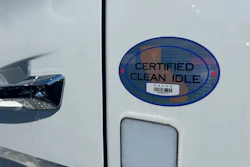 Certified Clean Idle sticker on white vehicle door with barcode label