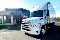 The new battery-electric Hino Trucks LE Series truck sits parked outside a building.