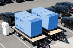 A pair of SparkCharge mobile, off-grid charging units on trailers parked at an electric vehicle fleet lot.