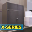OMX-Series industrial cooling equipment displayed at trade show with gray cabinet units and white product boxes
