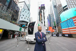 Einride CEO Roozbeh Charli stands outside Nasdaq in Times Square on June 10, 2026, with an autonomous battery-electric truck parked behind him.