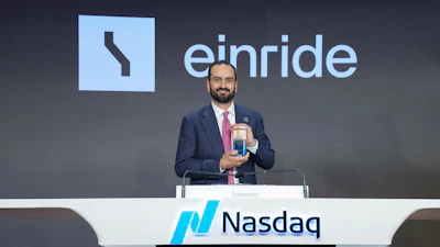 Einride CEO Roozbeh Charli standing at the Nasdaq podium.