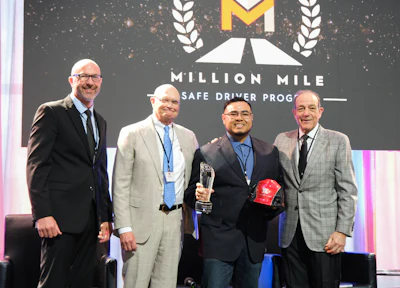 PGT Trucking inducted five new Million Mile Drivers for safe driving in 2025, including Christian Garcia, shown on stage with COO Chad Marsilio, President Gregg Troian and CEO Pat Gallagher.