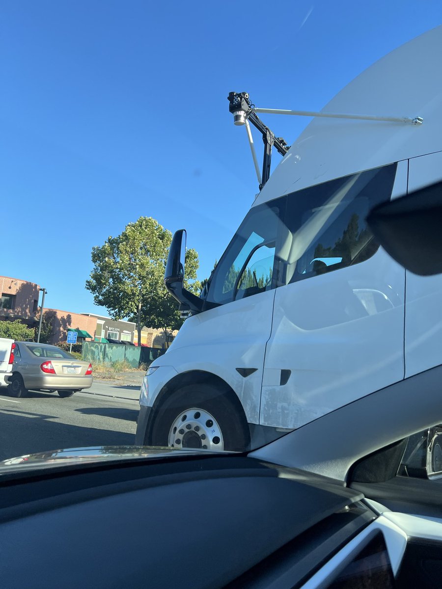 A white Tesla Semi equipped with self-driving hardware undergoing public road testing in California.