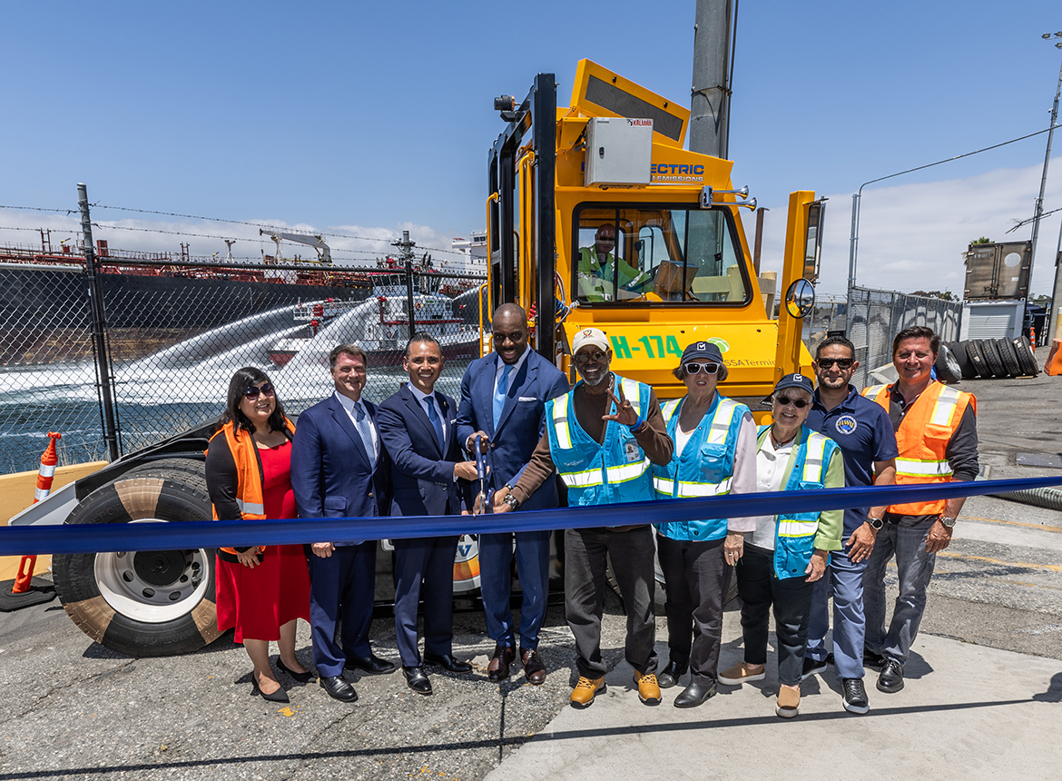 California State Transportation Agency (CalSTA) Secretary Toks Omishakin cutting a blue ribbon with state and port officials at the Port of Long Beach.