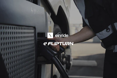 An individual is shown charging an electric semi-truck with the Einride and Flipturn brand logos on display.