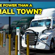 Electric trucks charging at station with text 'More Power Than a Small Town'