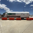 Hyroad liquid hydrogen transport trailer parked at industrial facility with red safety barriers