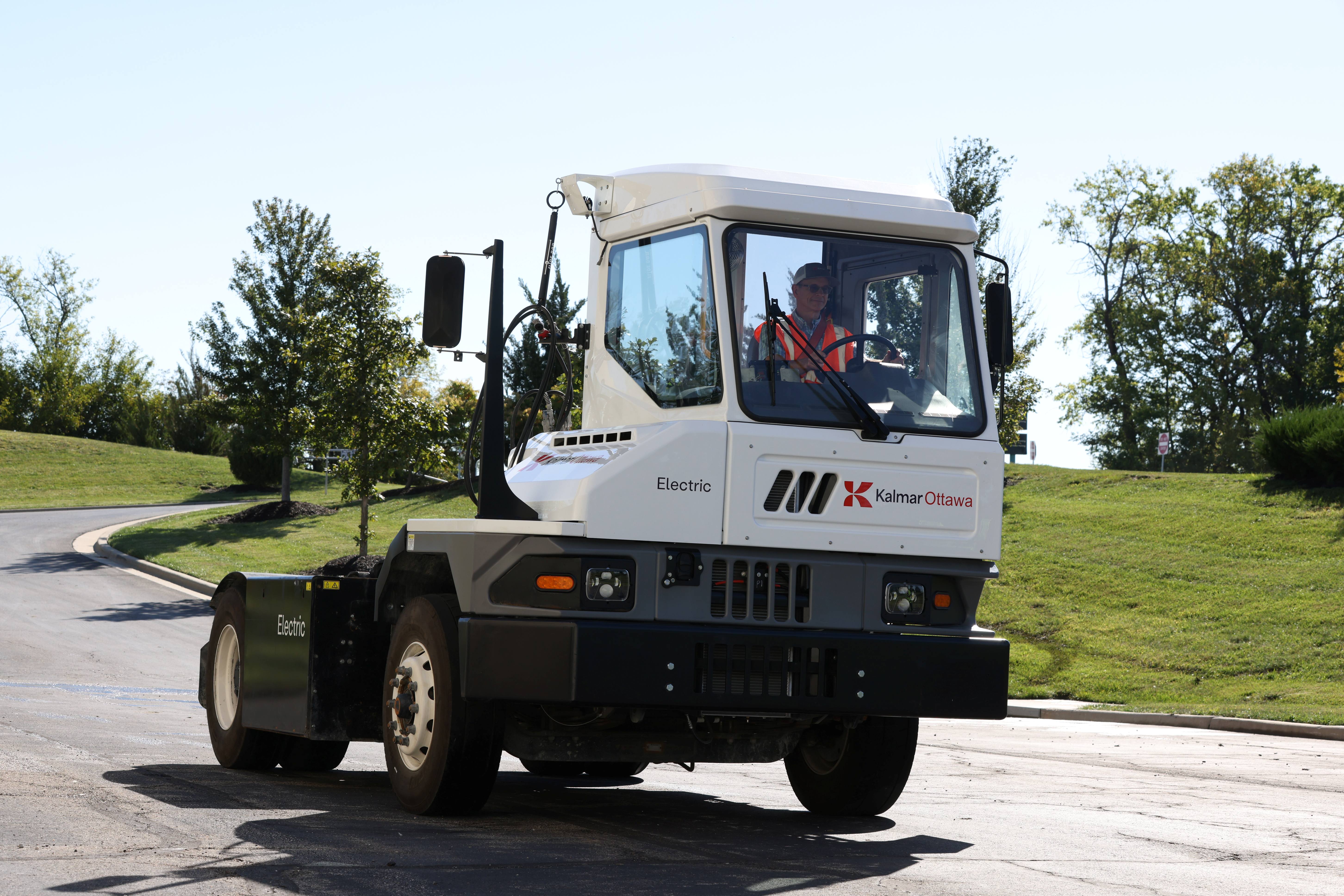 The Kalmar Ottawa T2 battery-electric terminal tractor driving on the road.