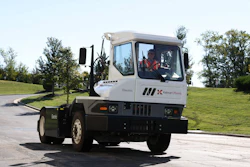The Kalmar Ottawa T2 battery-electric terminal tractor driving on the road.