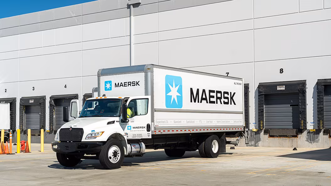 A white Maersk delivery truck sits outside a warehouse loading dock, highlighting the company&rsquo;s expanding ground freight operations.