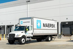 A white Maersk delivery truck sits outside a warehouse loading dock, highlighting the company’s expanding ground freight operations.