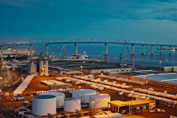 The Port of San Diego at dusk, with shipping containers and storage tanks visible throughout the terminal.