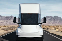 A front view of the updated Tesla Semi driving along a highway.