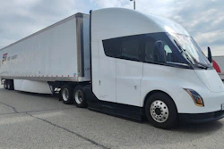 Paper Transport Inc.'s Tesla Semi Long Range is shown with a loaded trailer in an industrial yard during the company's Chicago pilot program.