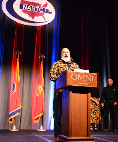 Wes Oberman from the stage addressing NASTC conference attendees after accepting the 2025 Small Fleet Champ award and title belt. Enter for 2026 before the July 31 deadline via this link.